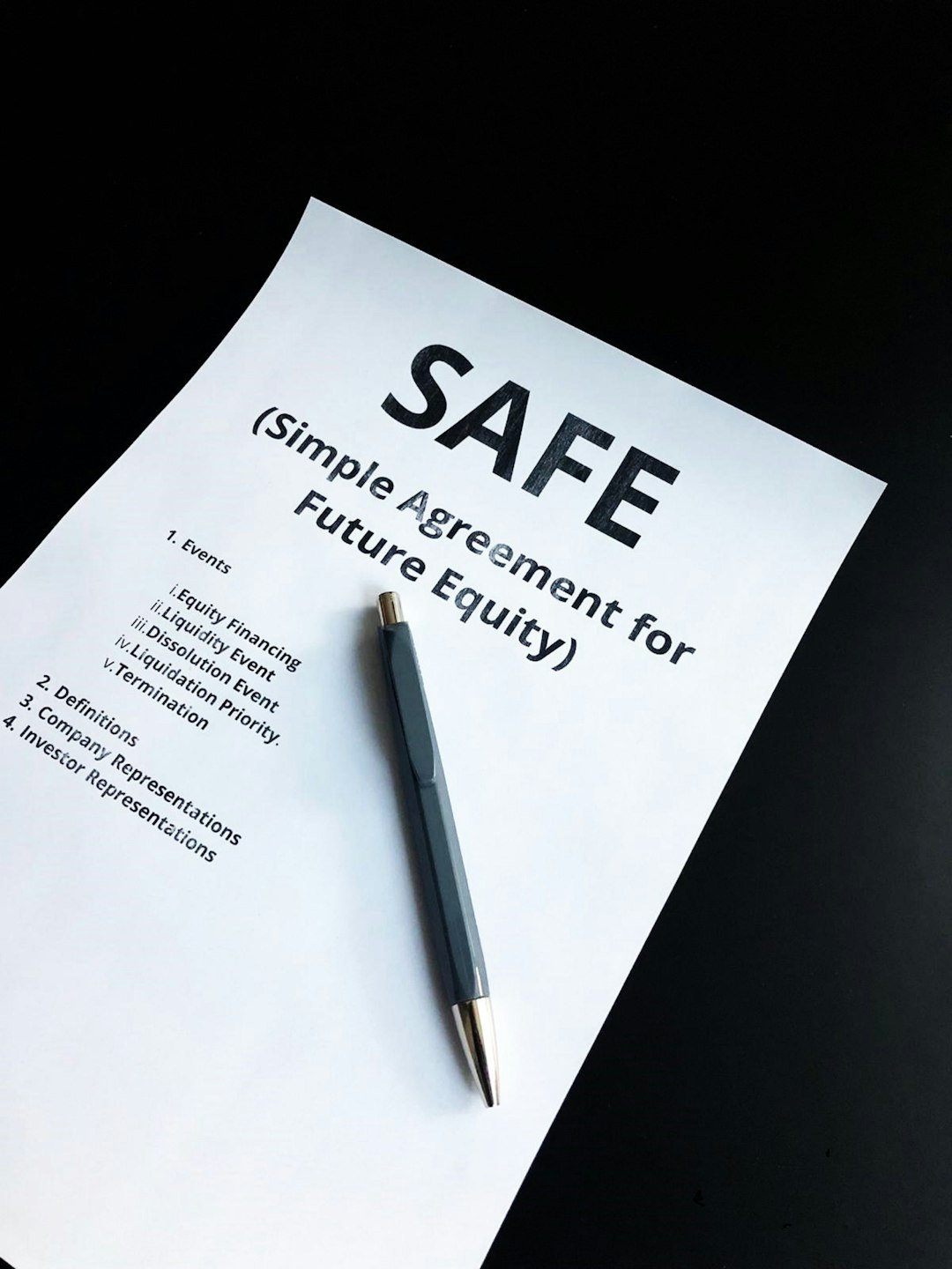 a-pen-sitting-on-top-of-a-piece-of-paper-a0hjhvz9ysc