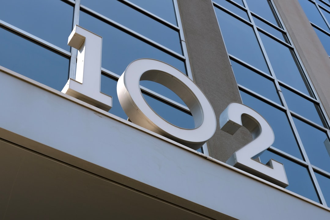 A large free-standing street number sign reading 102